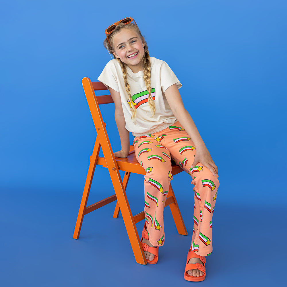 Peach based flare leggings with a shooting star print made with 95% organic cotton. Ethically produced, colorful and fun with an eye towards comfort, style and joy. Modern and sustainable kids clothing by CarlijnQ of the Netherlands.