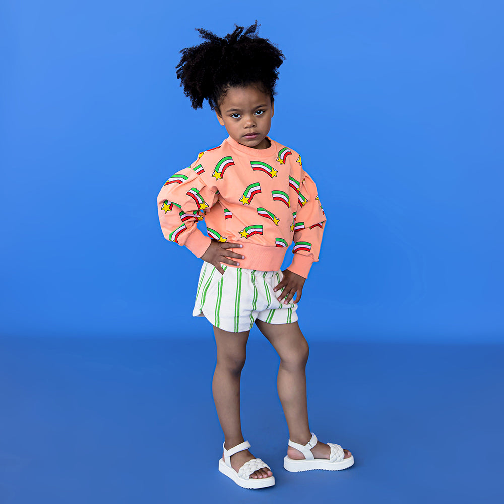 Peach crewneck with puffed sleeves, featuring a shooting star print.  Ethically produced, colorful and fun with an eye towards comfort, style and joy. Modern and sustainable kids clothing by CarlijnQ of the Netherlands.