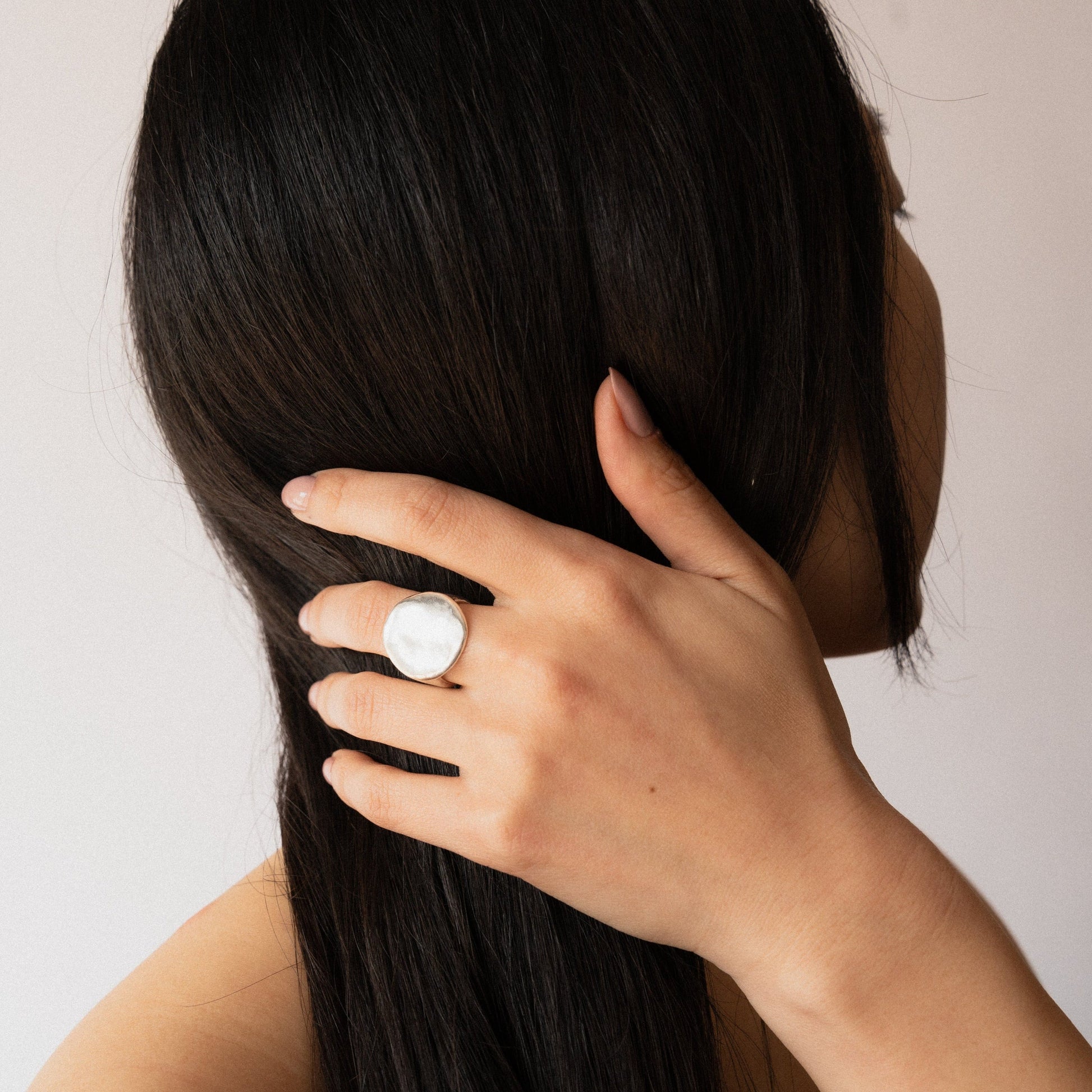 Crafted meticulously in shimmering bronze or sterling silver, with a watery finish, this ring makes a bold statement, both in weight and appearance, inviting wearers to embrace their inner strength and intuition. Handmade in Santa Cruz by Amanda Hunt.