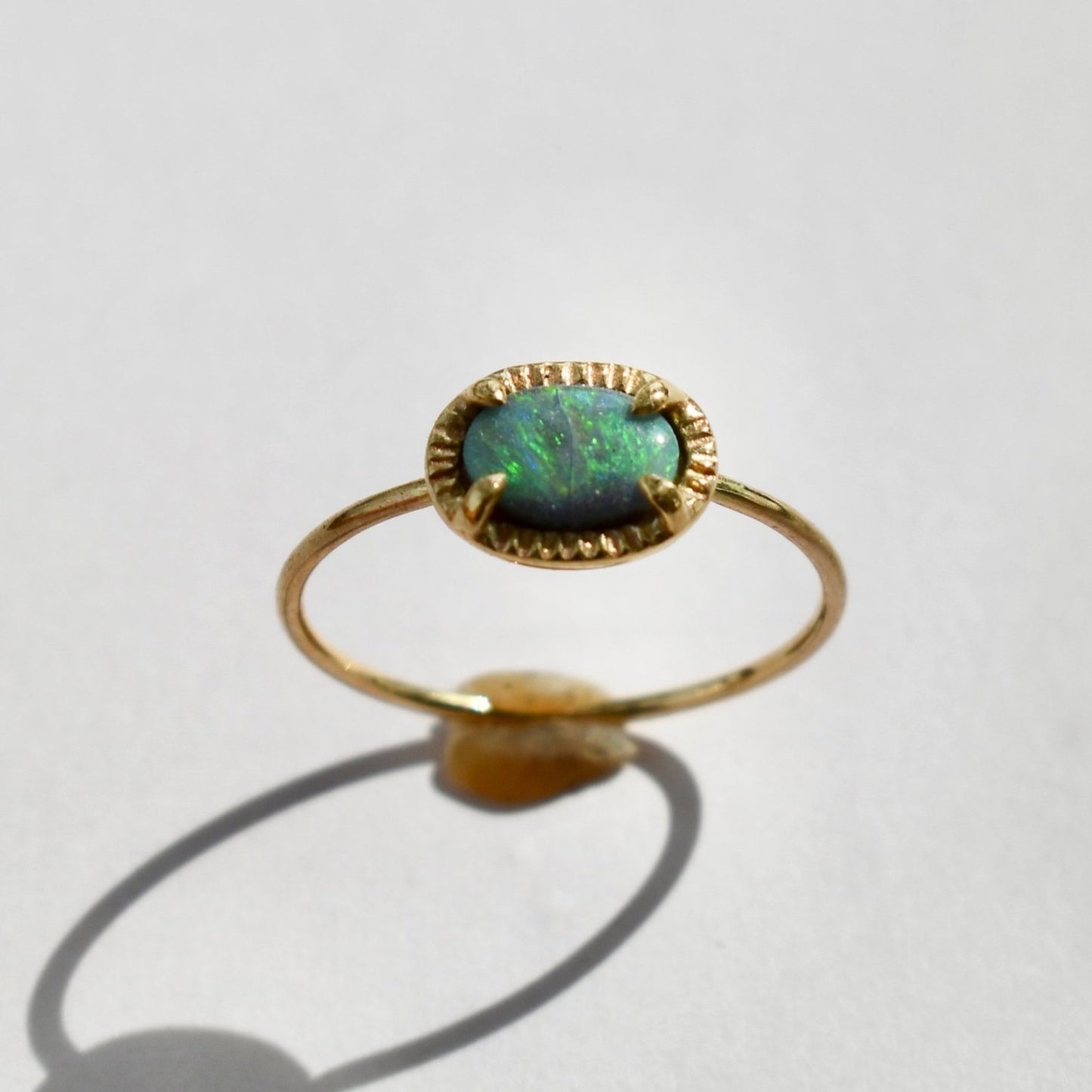 Made by hand in Northern New Mexico using recycled metals and responsibly sourced stones, this timeless, heirloom piece is sure to make a statement. This ring features a 14kt yellow gold 1 mm band with an Australian boulder opal.
