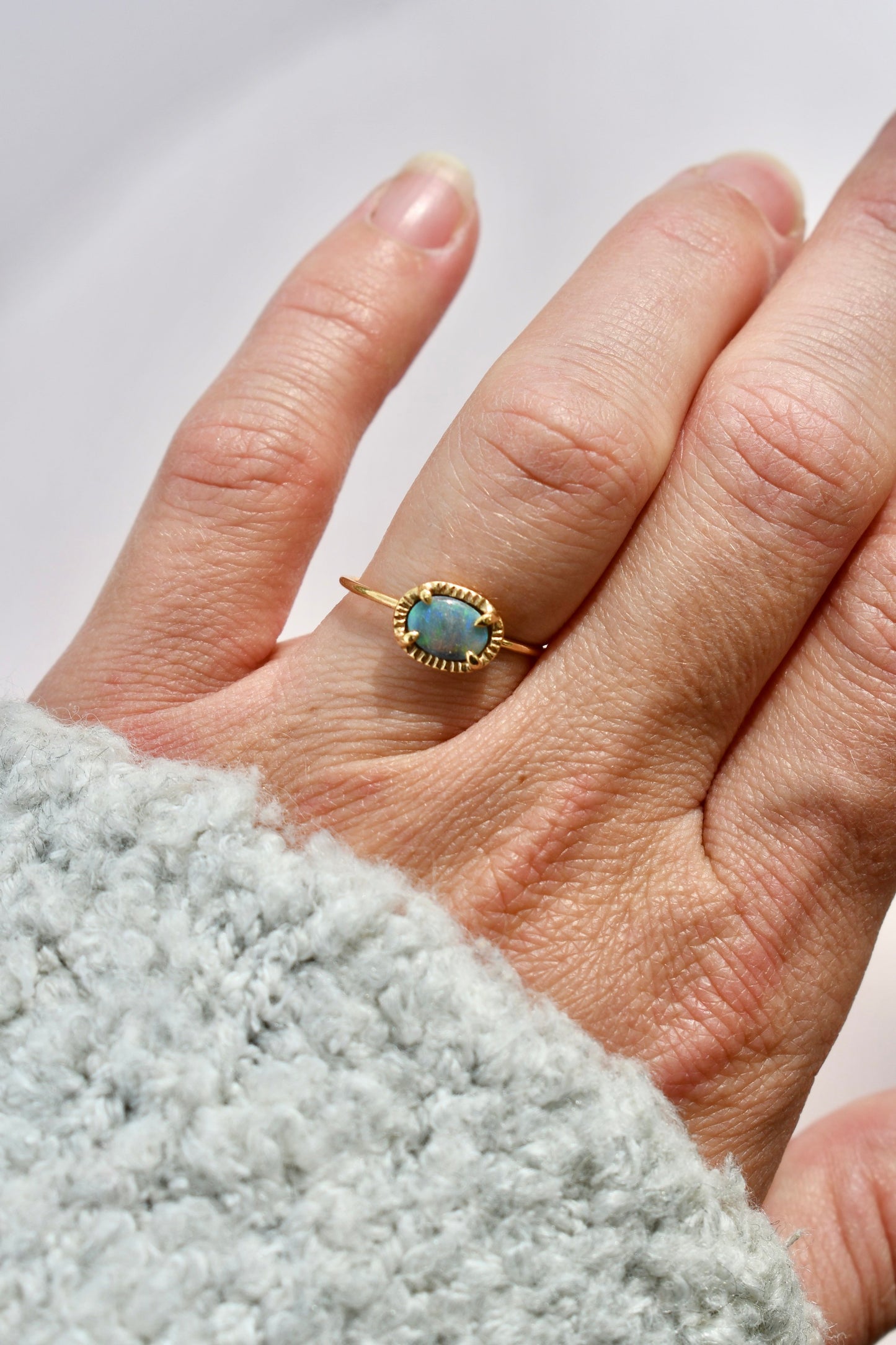 Made by hand in Northern New Mexico using recycled metals and responsibly sourced stones, this timeless, heirloom piece is sure to make a statement. This ring features a 14kt yellow gold 1 mm band with an Australian boulder opal.