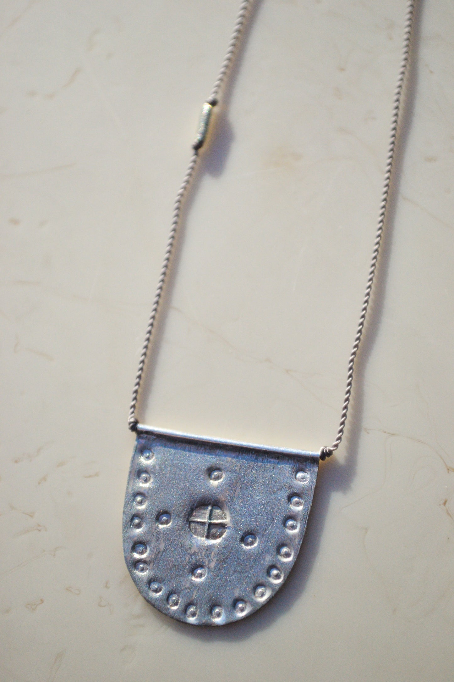 riversong jewelry / riversong jewelry / Talisman Collection: Born from a long standing partnership with two Turkish artists, each piece is hand-stamped with antique imagery.


A symbol of world citizenry to be worn for personal protection and happy travels. Intended for daily wear and to gently form a time worn patina.