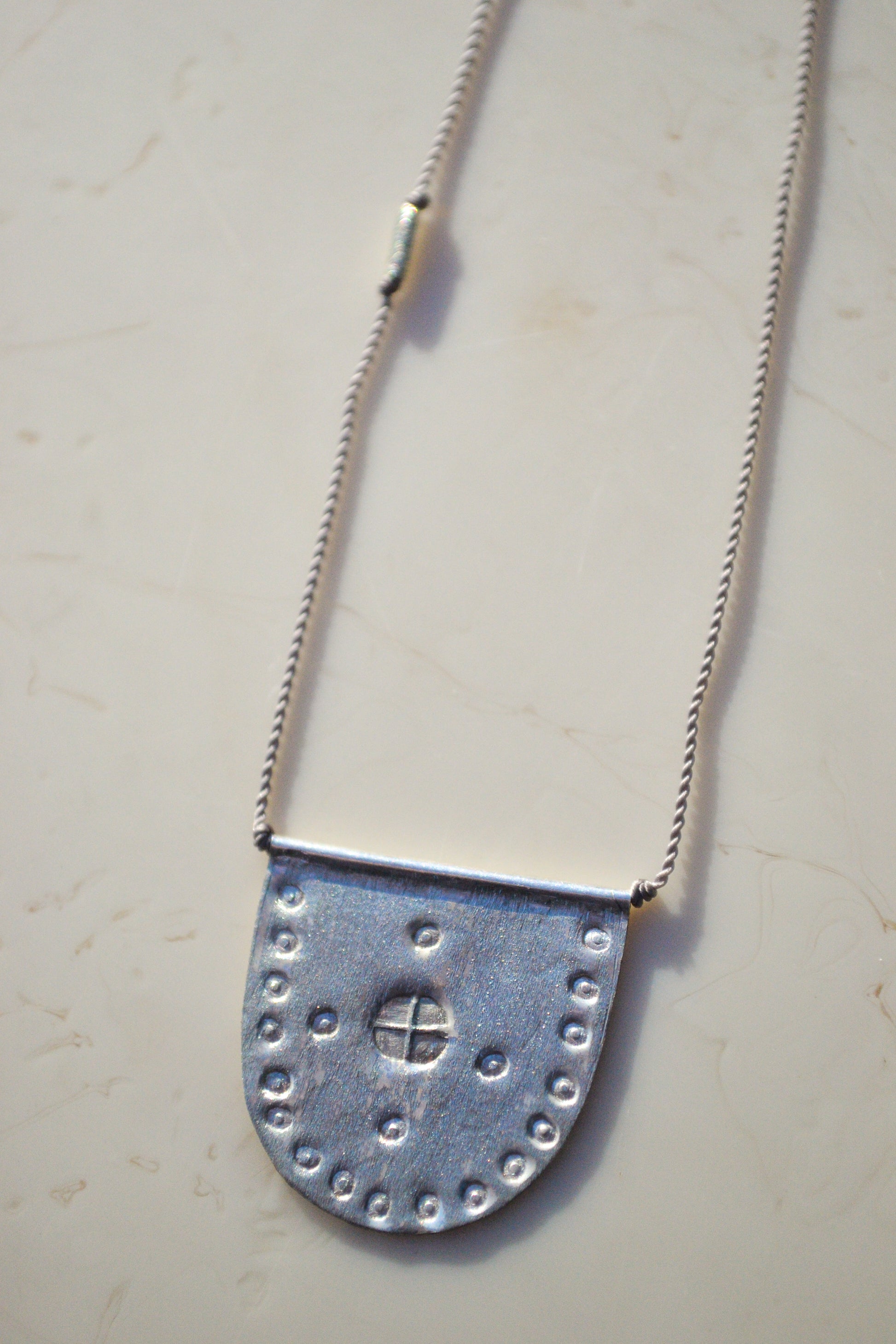 riversong jewelry / riversong jewelry / Talisman Collection: Born from a long standing partnership with two Turkish artists, each piece is hand-stamped with antique imagery.


A symbol of world citizenry to be worn for personal protection and happy travels. Intended for daily wear and to gently form a time worn patina.