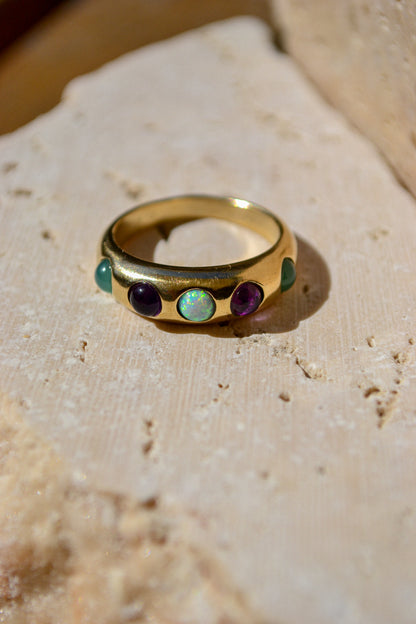 Bold and beautiful, the confetti ring is the life of the party. Featuring an assortment of genuine stones - teal chrysoprase, purple iolite, and sparkly opal