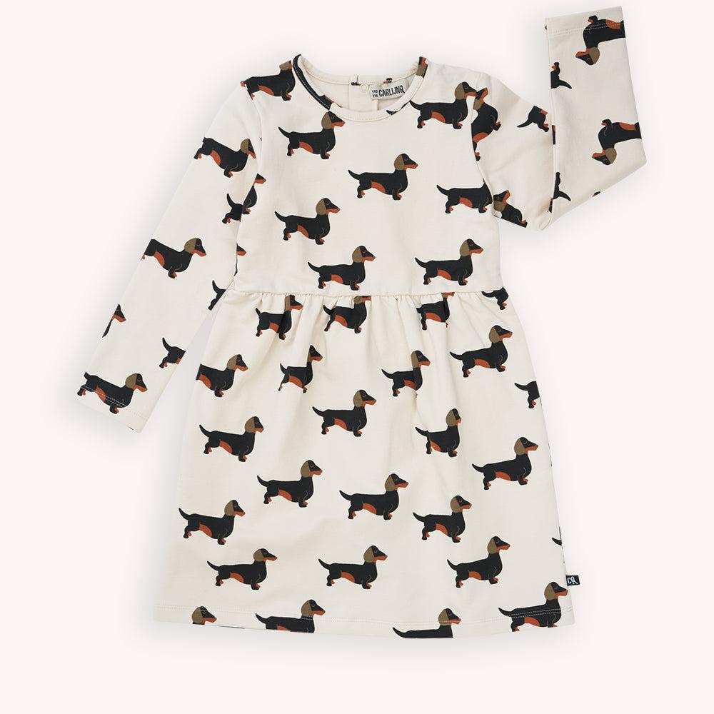 Off white long sleeved dress with a dachshund print made with 95% organic cotton. Ethically produced, colorful and fun with an eye towards comfort, style and joy. Modern and sustainable kids clothing by CarlijnQ of the Netherlands.