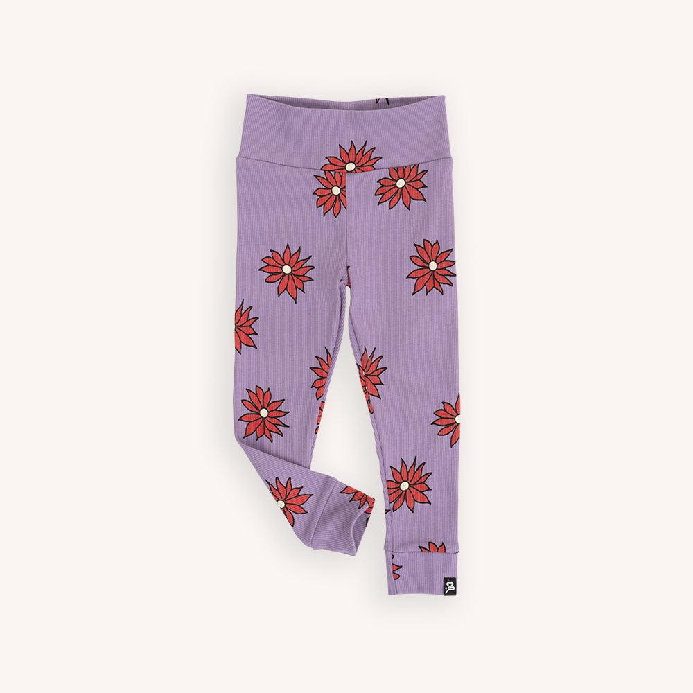 Purple based legging with a red flower print made with 95% organic cotton. Ethically produced, colorful and fun with an eye towards comfort, style and joy. Modern and sustainable kids clothing by CarlijnQ of the Netherlands.