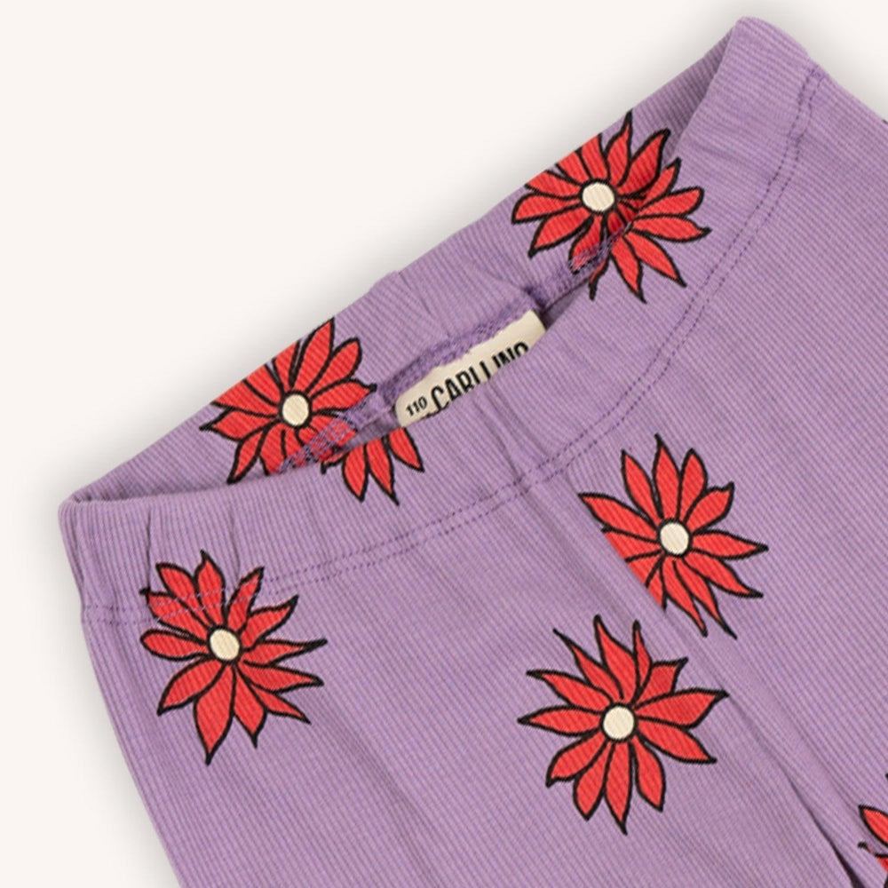 Purple based flared legging with a red flower print made with 95% organic cotton. Ethically produced, colorful and fun with an eye towards comfort, style and joy. Modern and sustainable kids clothing by CarlijnQ of the Netherlands.