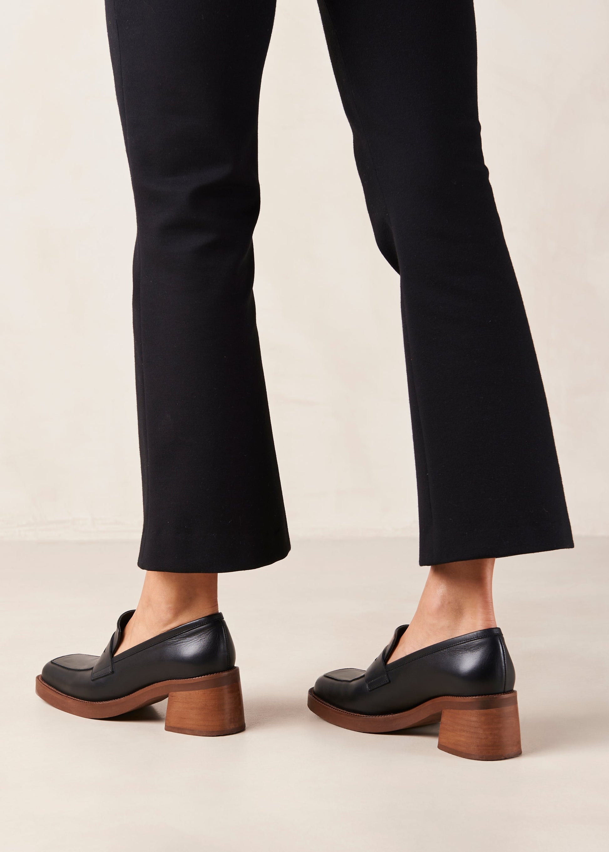 If you are always game for extra height, Roxanne is the loafer-pump hybrid you have been craving for. Think your evergreen moccasin silhouette set atop a chunky block heel for a little flattering elevation. They come in premium black leather and feature the classic penny tab across the vamp. Sustainably made in Spain. Alohas Roxanne Black Leather Loafer.