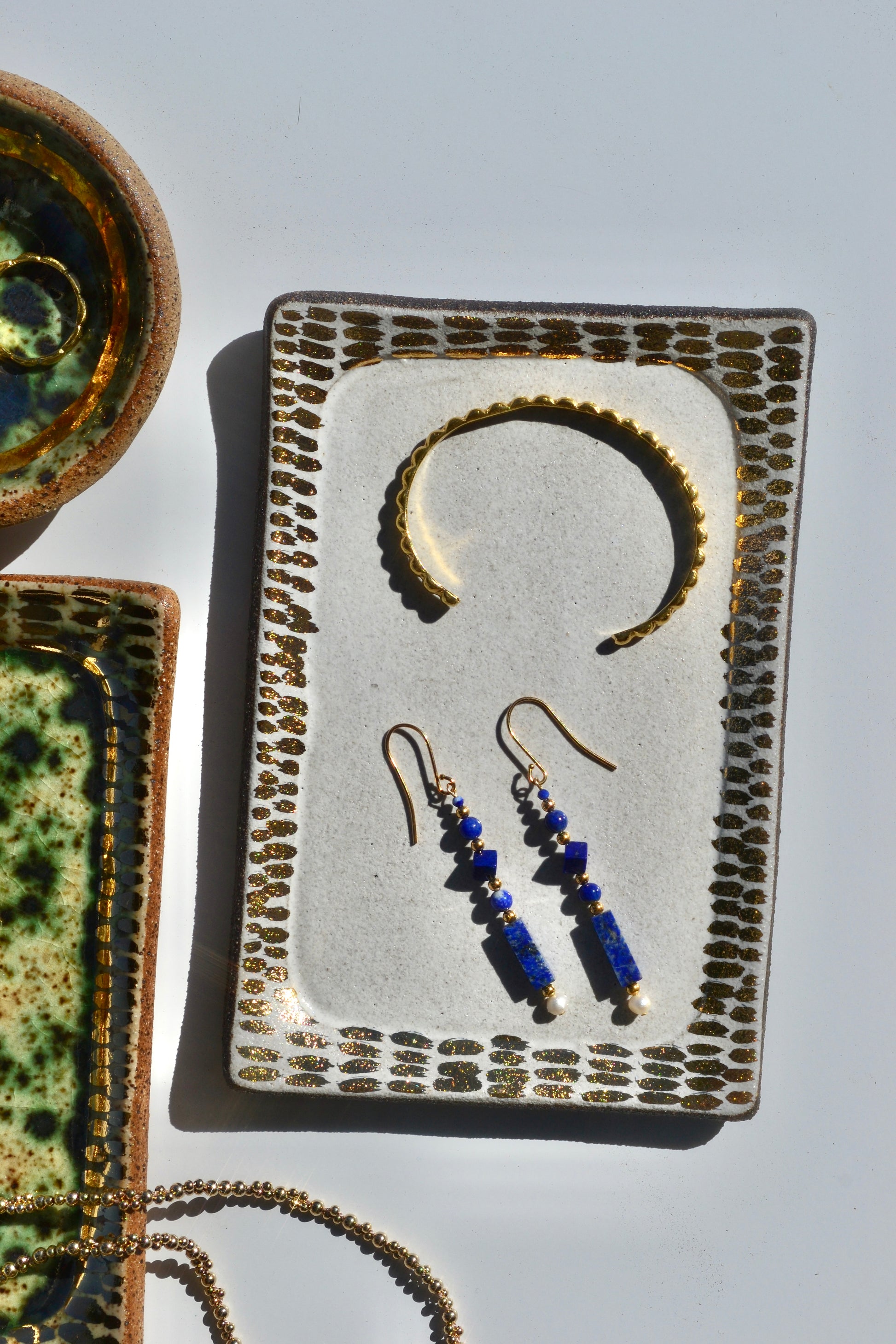 Perfect for holding a few small treasured items like rings and small jewelry items, keys, or incense bundles. Thoughtfully made with obsidian stoneware & hand painted with 22k gold luster accents
