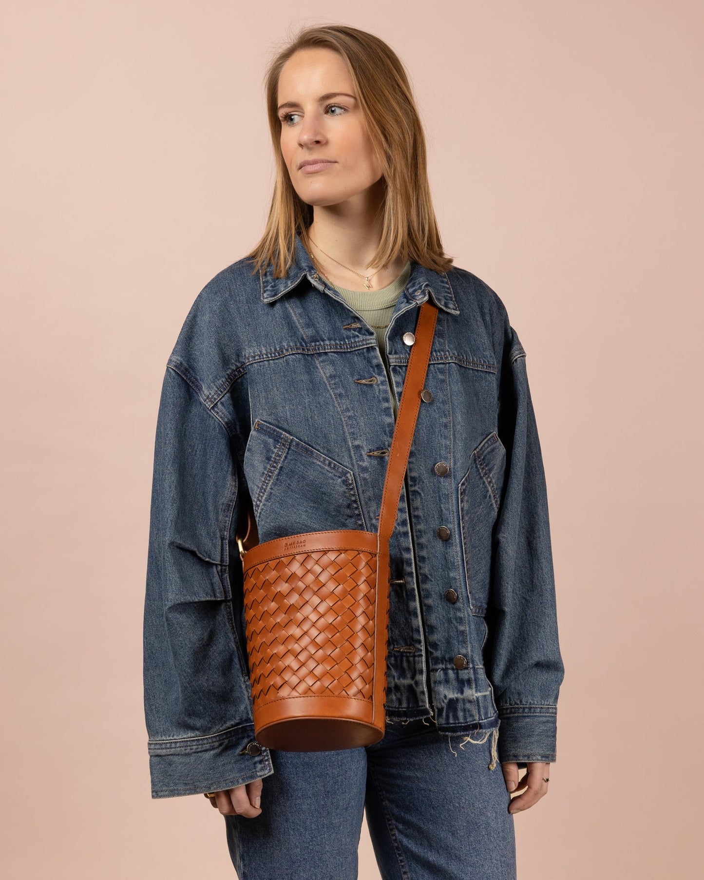 o my bag / With a round design, drawstring closure, and an adjustable leather strap, Zola adapts effortlessly to your style. Inside, find a zipper pocket and slip pocket for organization. Zola transitions seamlessly from shoulder to cross-body. Ethically made in India.
