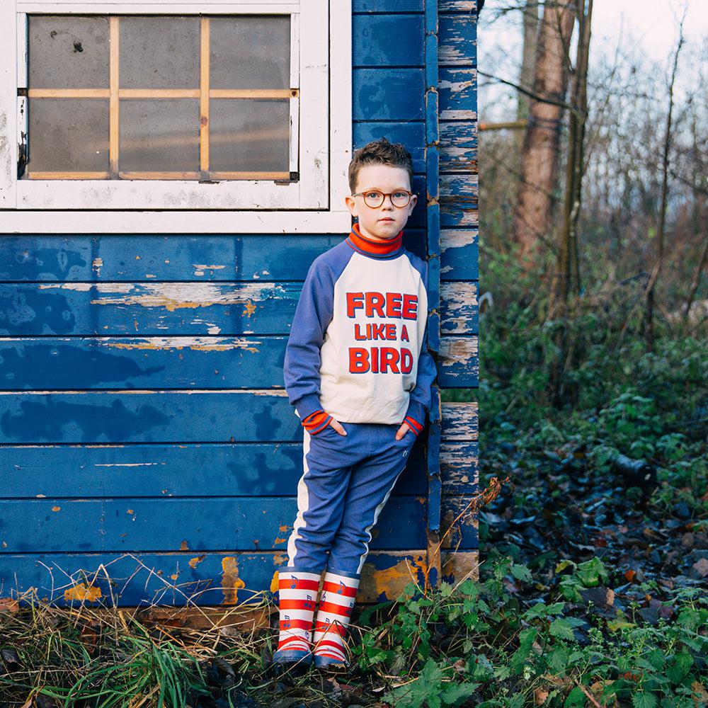 Off white based sweatshirt with navy sleeves made with 95% organic cotton. Ethically produced, colorful and fun with an eye towards comfort, style and joy. Modern and sustainable kids clothing by CarlijnQ of the Netherlands.