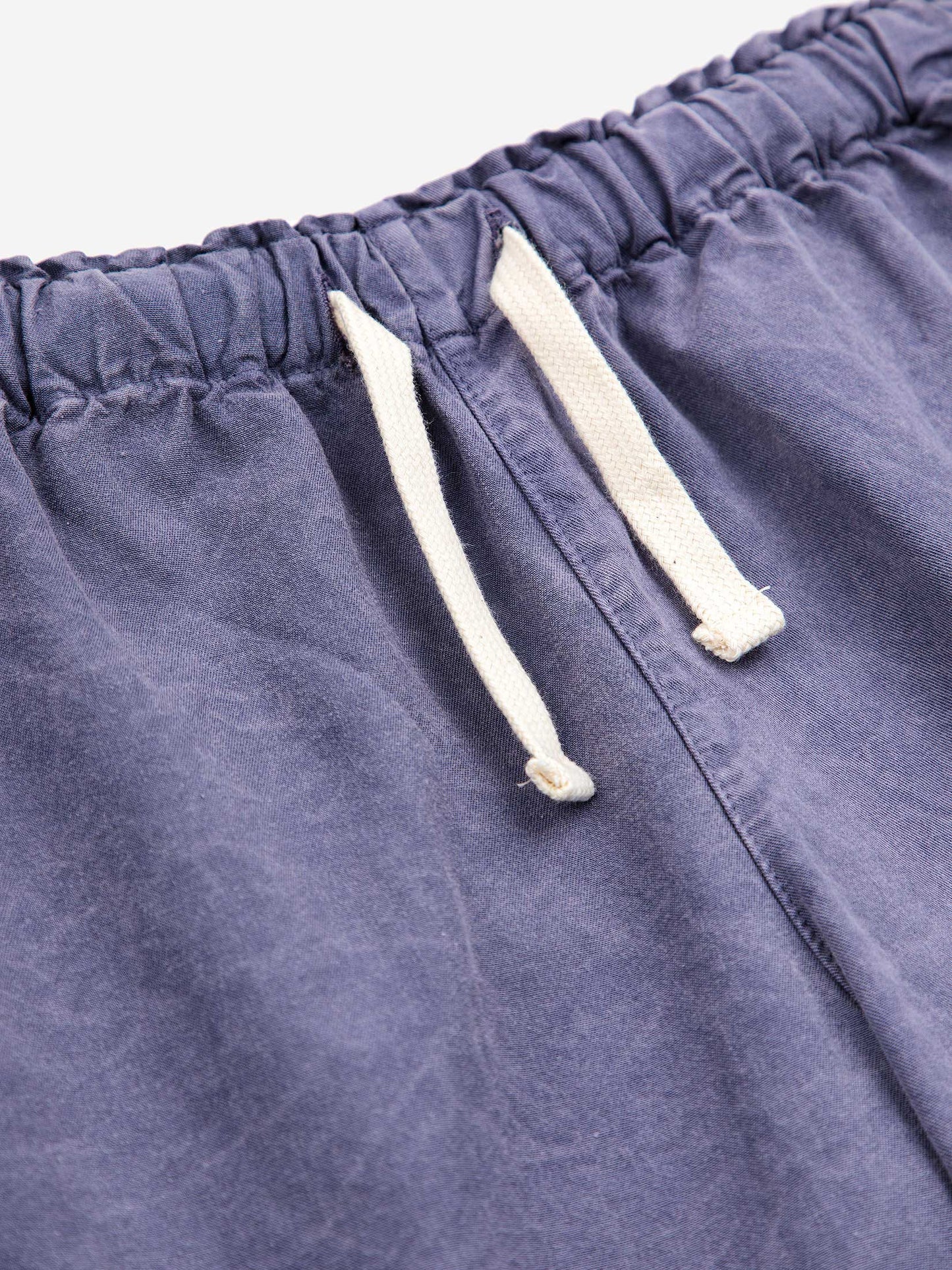 Circle Woven Bermuda Shorts by Bobo Choses. 100% BCI cotton Prussian blue Bermuda style shorts with Bobo Choses circle decal.