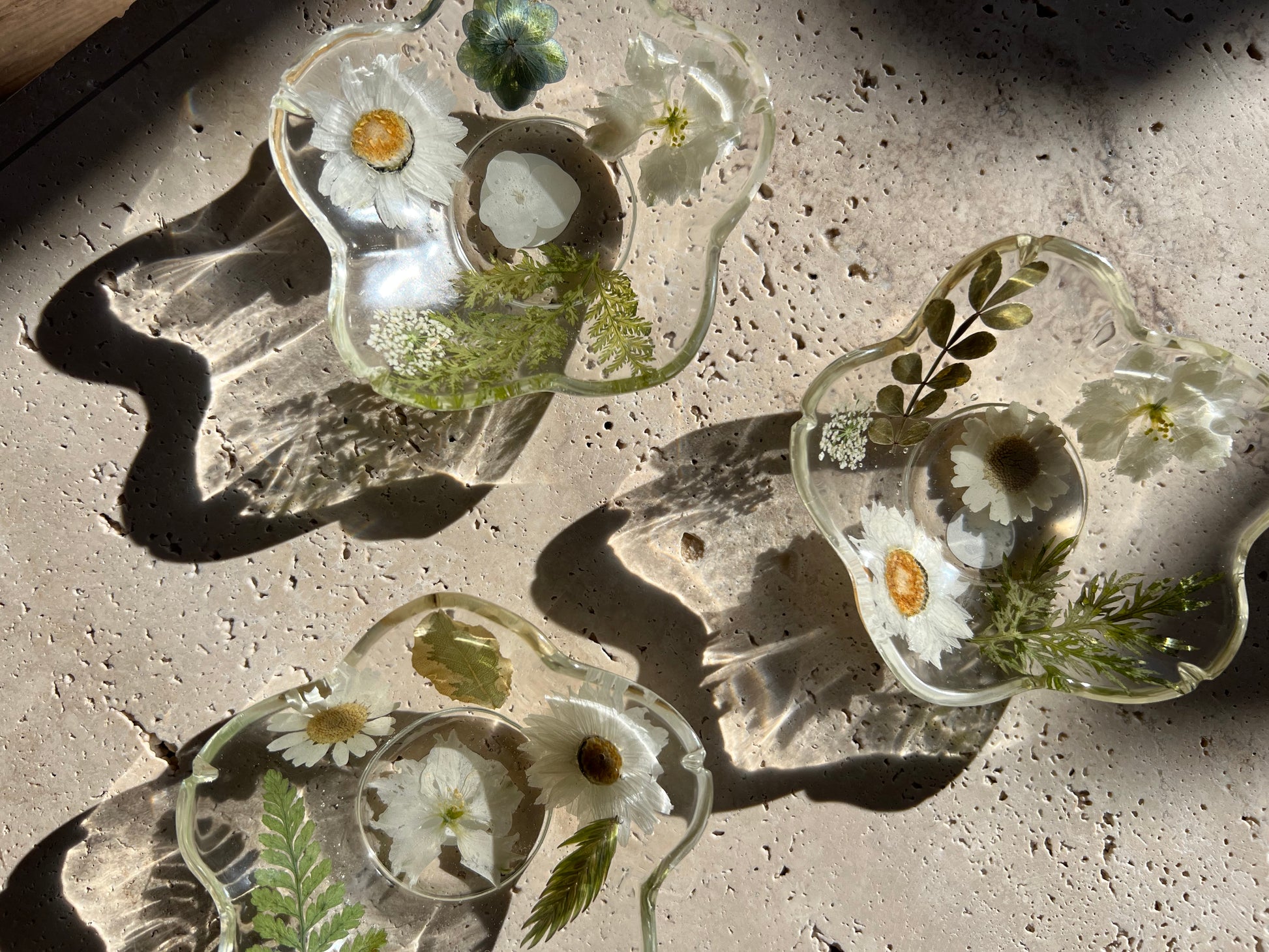 Functional art objects using hand-sourced, dried flowers encased in resin. Each piece is one of a kind and totally unique, made by hand in Lee Meszaros' home studio in Hamilton, Ontario.