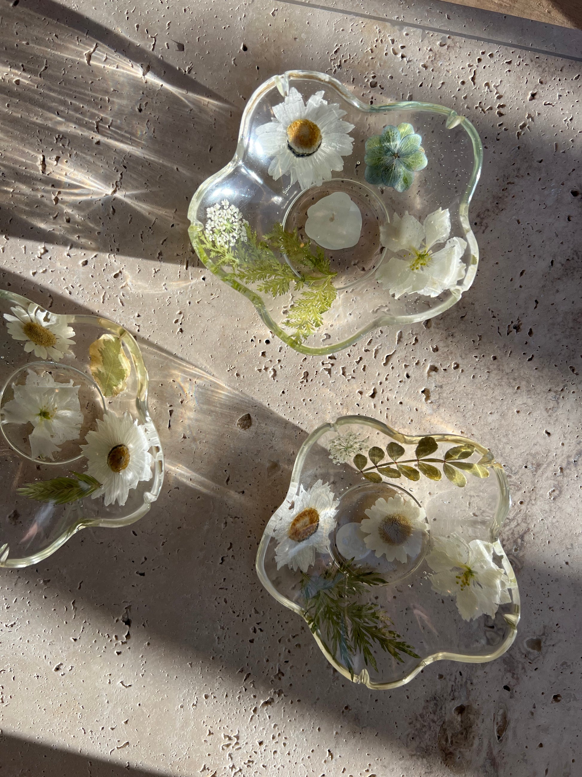 Functional art objects using hand-sourced, dried flowers encased in resin. Each piece is one of a kind and totally unique, made by hand in Lee Meszaros' home studio in Hamilton, Ontario.
