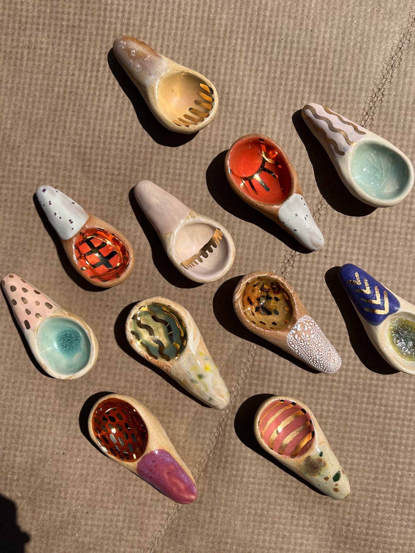 Handmade ceramic sugar spoons that are as sweet and colorful as the sugar (or any other spice) you can scoop with them! These make a great gift. Each is entirely one of a kind featuring fun designs and colors.