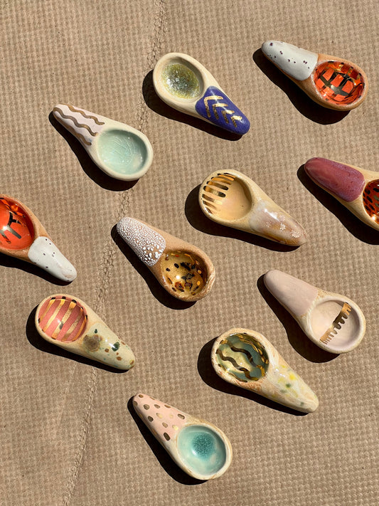 Handmade ceramic sugar spoons that are as sweet and colorful as the sugar (or any other spice) you can scoop with them! These make a great gift. Each is entirely one of a kind featuring fun designs and colors.