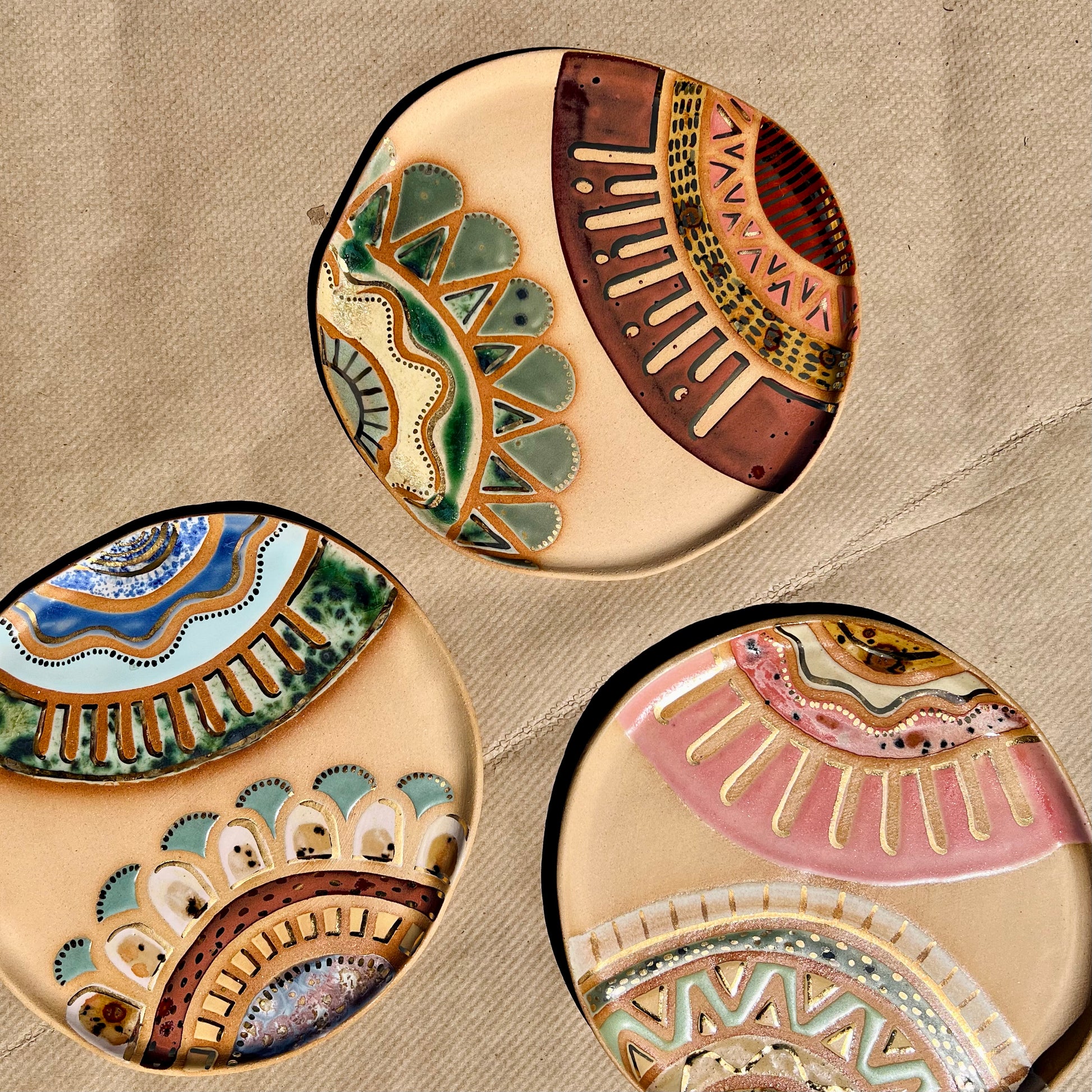 Handmade ceramic dish featuring fun designs and gold luster accents.