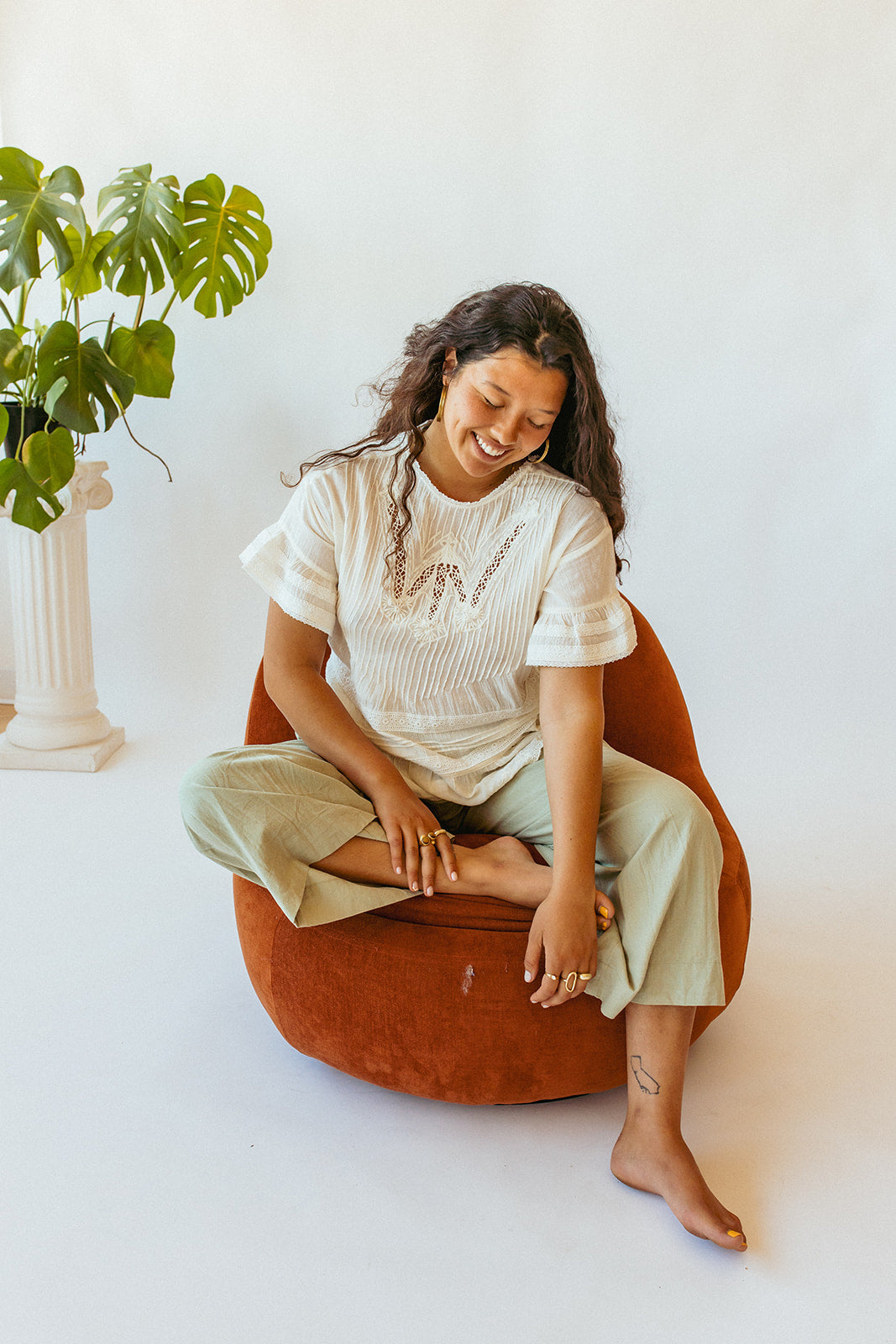 Woman wearing sustainable linen pants and a handmade Louise Misha top
