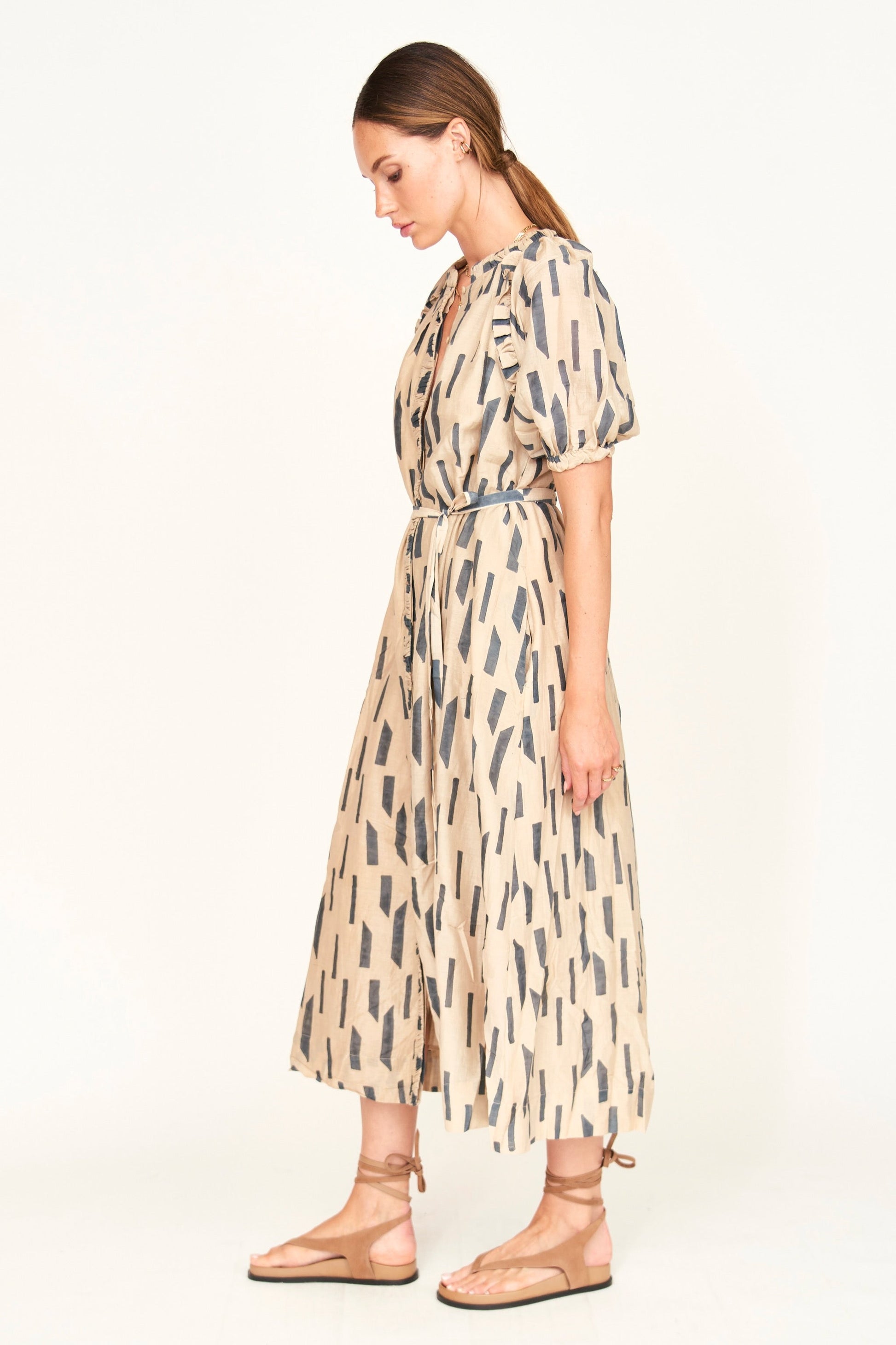 The Somerset Dress is a hand block printed, Midi length dress with high low hem, and raglan sleeves and ruffle detailing.