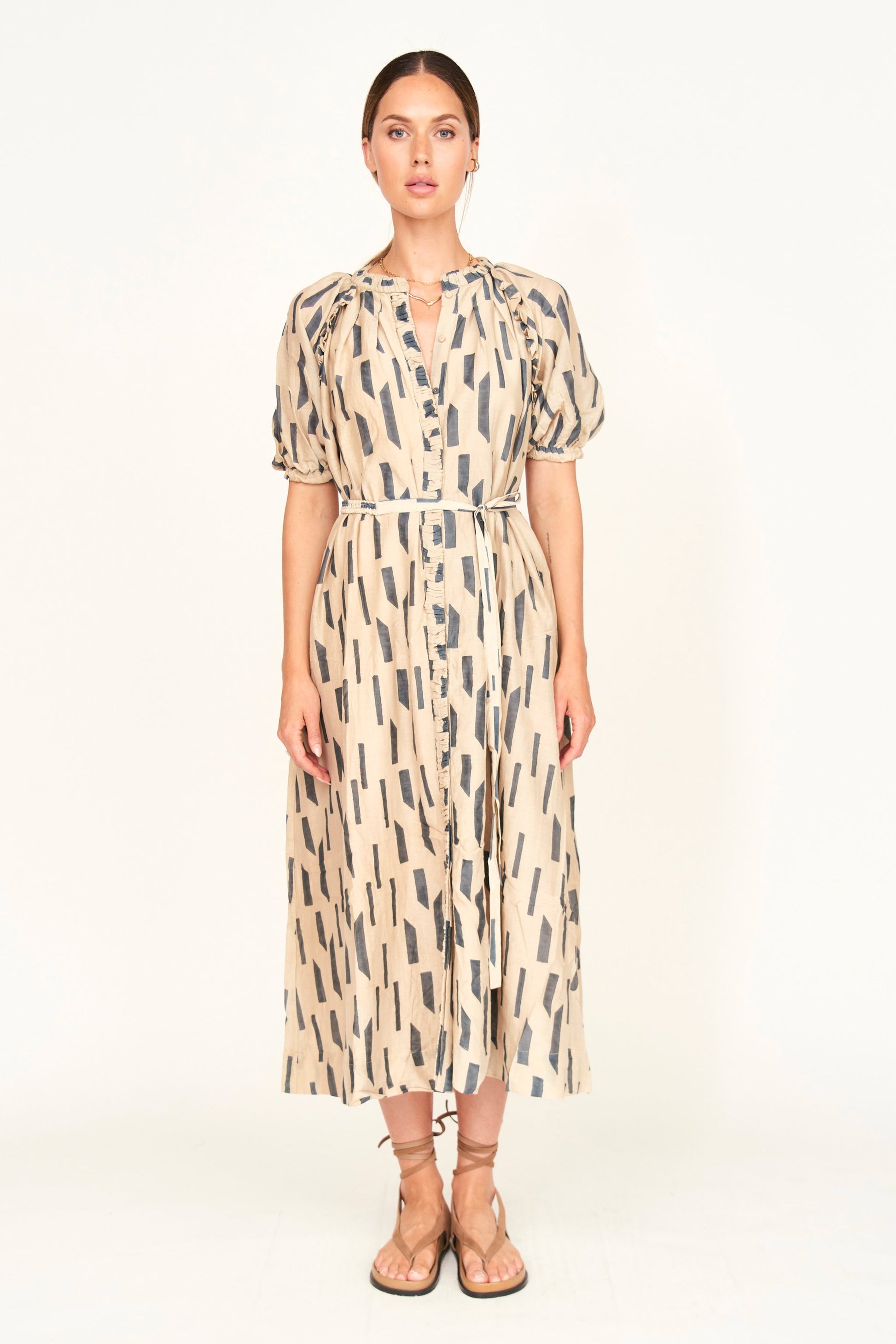 The Somerset Dress is a hand block printed, Midi length dress with high low hem, and raglan sleeves and ruffle detailing.
