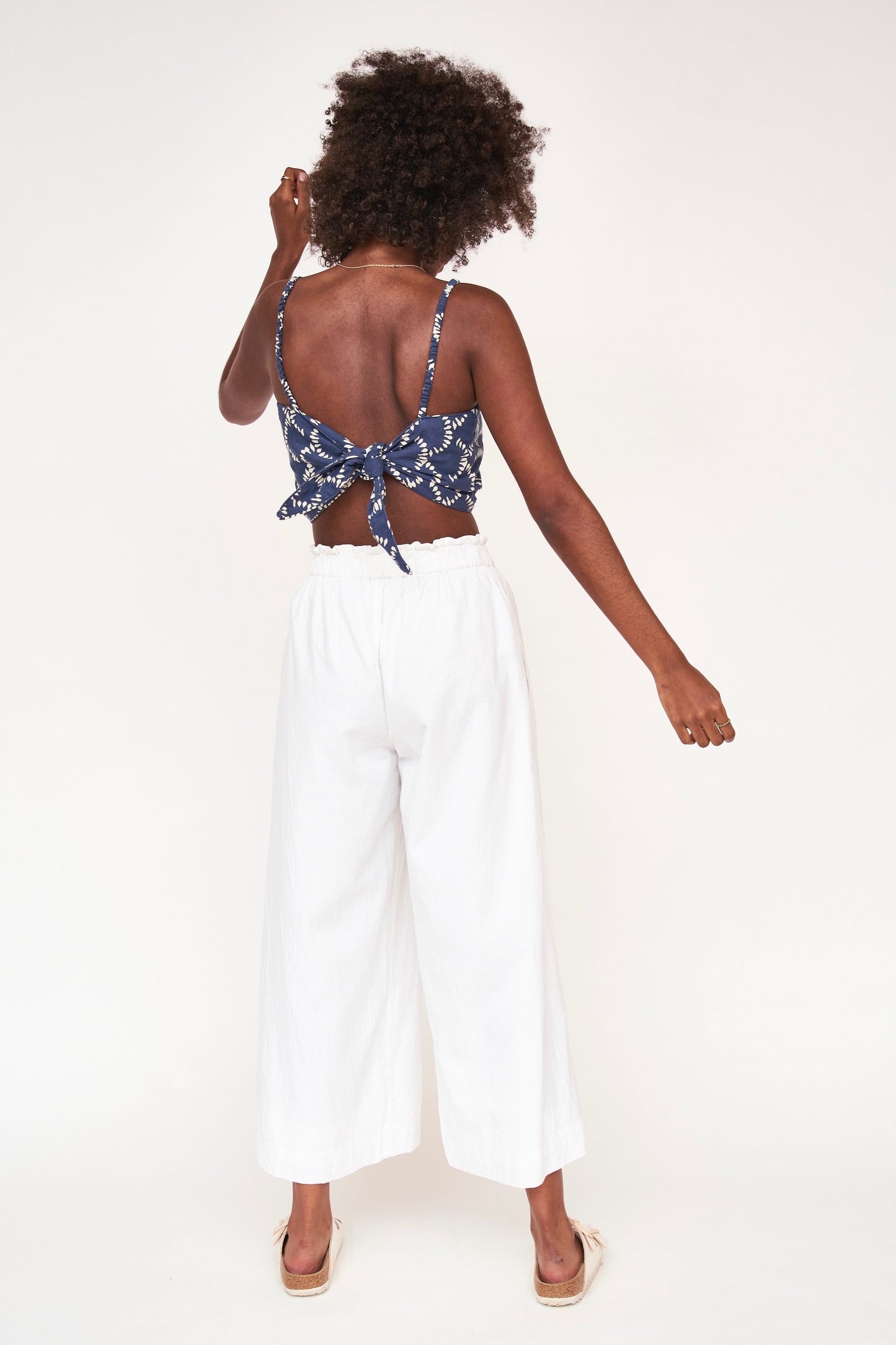 Consider this a bra top with a bit more coverage. The tie back and elastic straps allow for a perfect fit. Ethically made with 100% cotton in India.