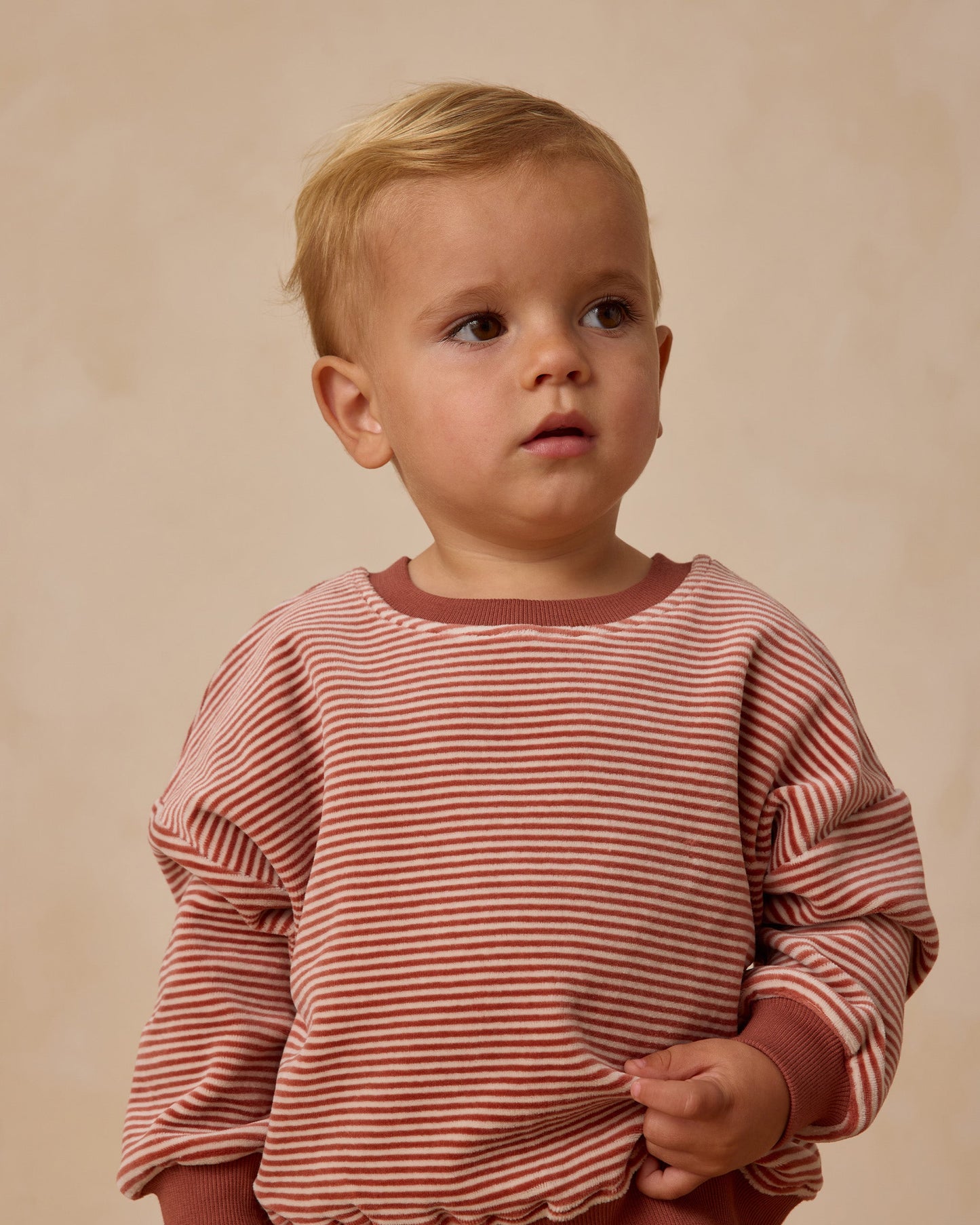 Child wearing a red and white striped shirt against a beige background / Quincy Mae Relaxed Velour Sweatshirt 