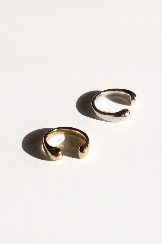 The Droplet ring is inspired by the round shape of falling rain. Hand carved and cast with a high polished mirror finish. Available in solid brass or sterling silver.
