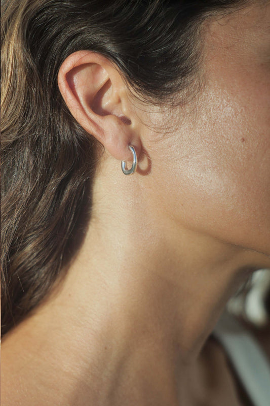 moneh brisel jewelry / The Fluid hoops embody the abstract and playful shape of water. The soft round edges and organic details serve as a reminder to flow with the day ahead of you. Perfect mini everyday hoops.