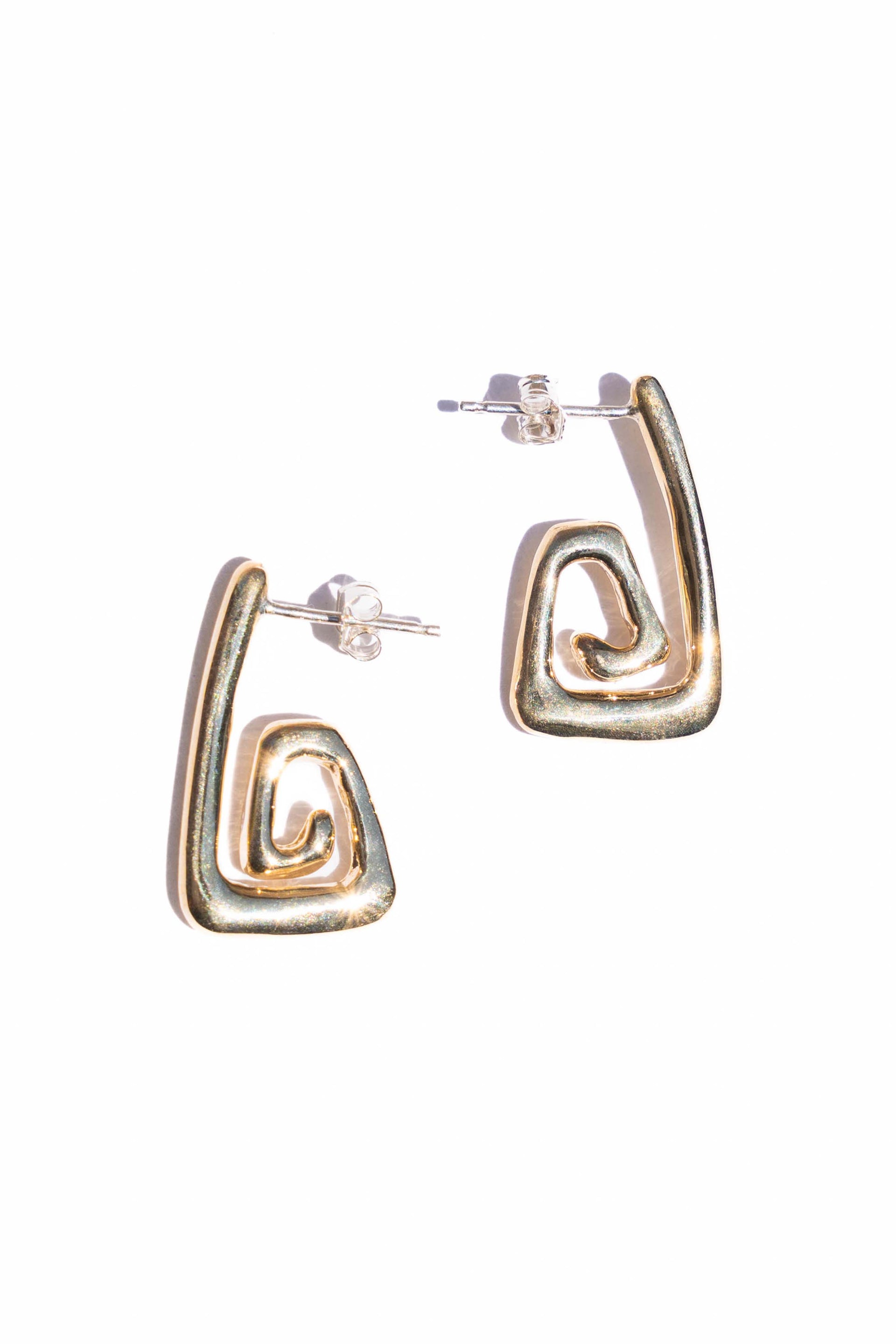 Pair of gold hoop earrings on a white background. Moneh Brisel Nautilo Earrings