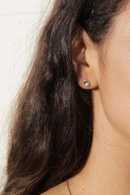 The Puddle stud is inspired by a calm small body of water. Perfect alone or in a second ear piercing.   Hand carved and cast with a high polished mirror finish. Available in solid brass or sterling silver.