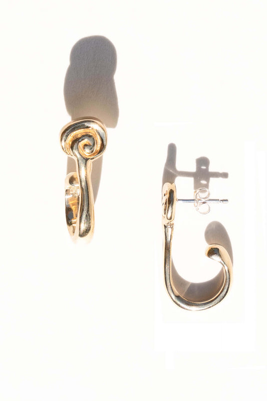 Gold hoop earrings on a white background. Moneh Brisel Espira Earrings