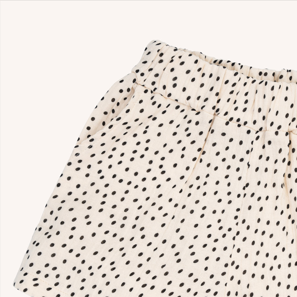 Light weight shorts with a longer fit. Elasticized waist band with pockets & a mini polka dot print.  Ethically produced, colorful and fun with an eye towards comfort, style and joy. Modern and sustainable kids clothing by CarlijnQ of the Netherlands.