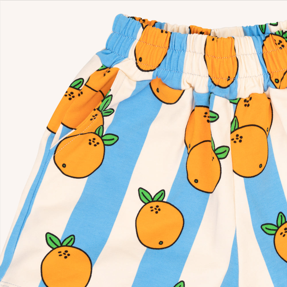 Light weight shorts with a longer fit. Elasticized waist band with pockets featuring blue & white stripes with oranges print. Ethically produced, colorful and fun with an eye towards comfort, style and joy. Modern and sustainable kids clothing by CarlijnQ of the Netherlands.