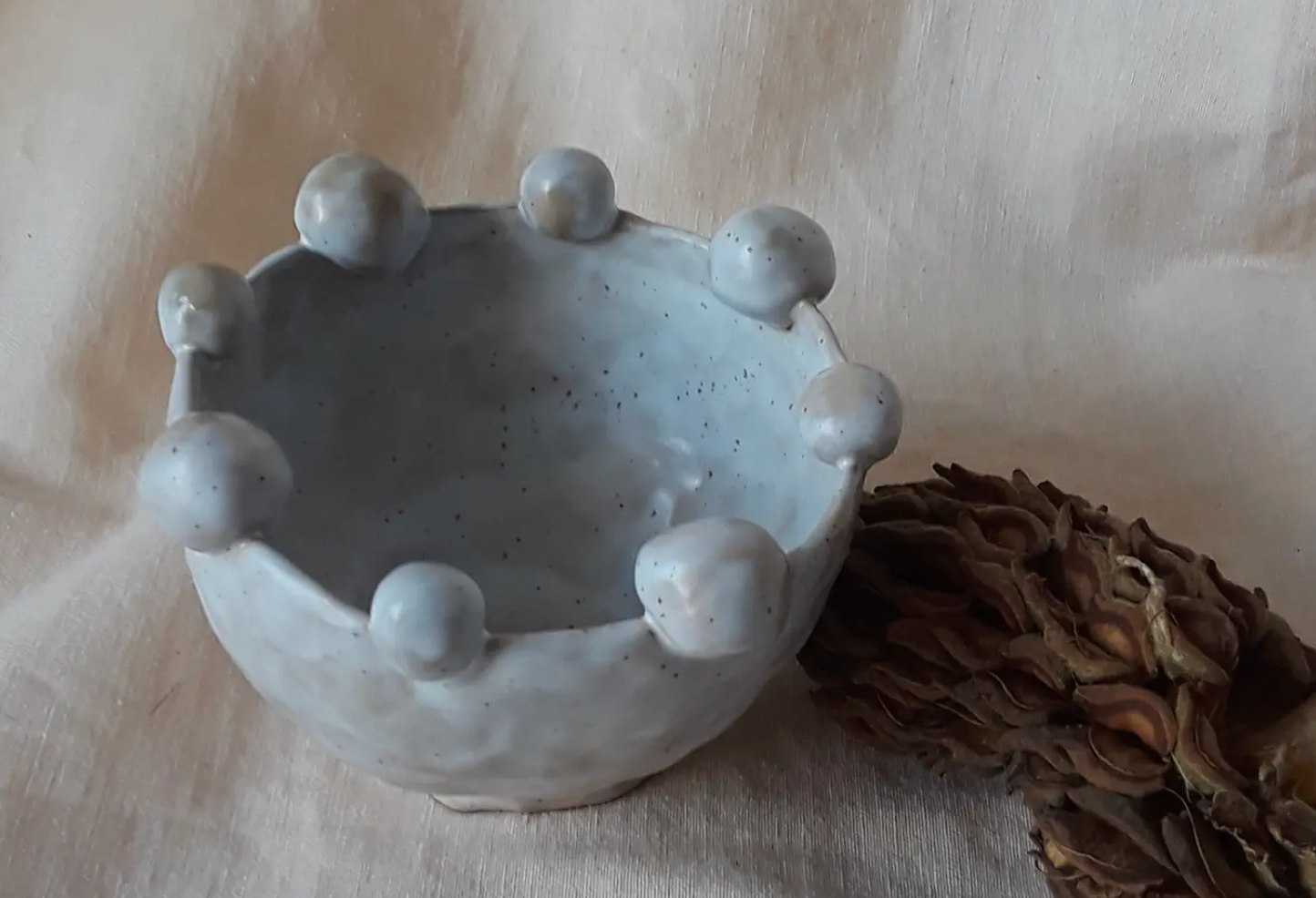 curious clay balance ball bowl with white speckled glaze available at thread spun