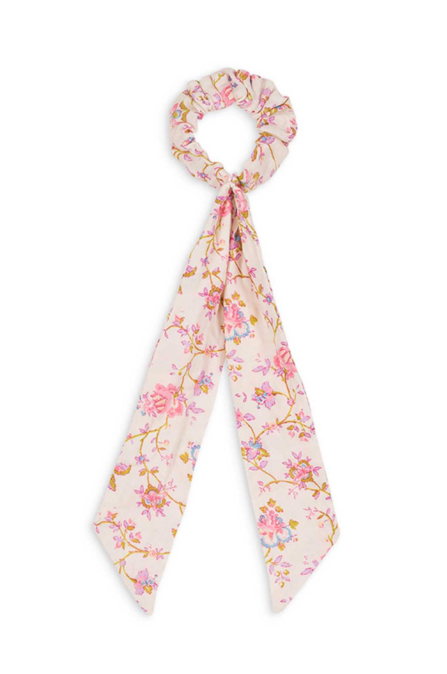 A floral hair scrunchie with a decorative bow. Made with 100% organic cotton. Louise Misha Akimmi Scrunchie.