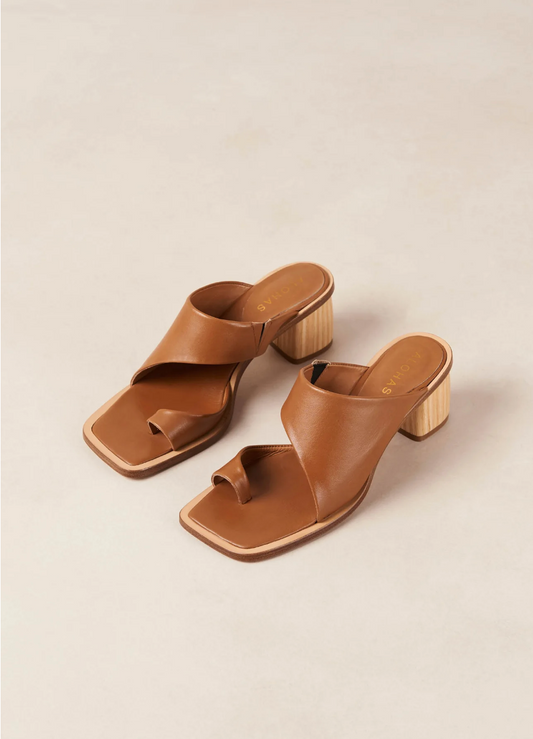 With only a toe ring and front strap, the Josie sandals slip on with ease like a mule. Crafted from brown leather, they have wood-style block heels as well as padded insoles for cushioning and comfort.  Sustainably made in Portugal, designed in Barcelona.