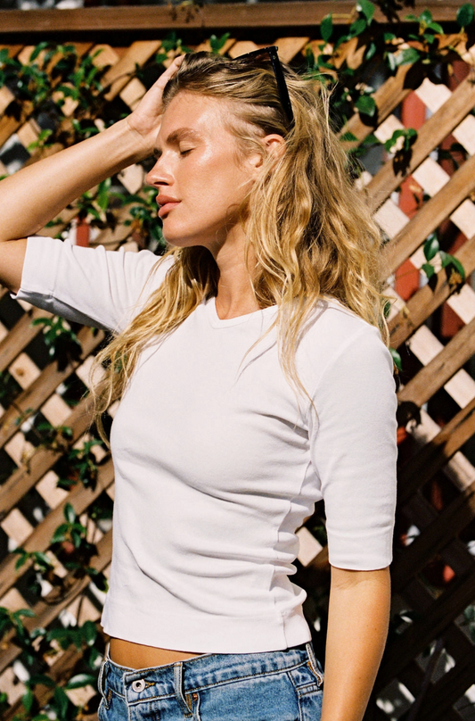 The perfect 90's inspired basic top. Features quarter length sleeves and a mini v neckline. 100% Organic Cotton.
