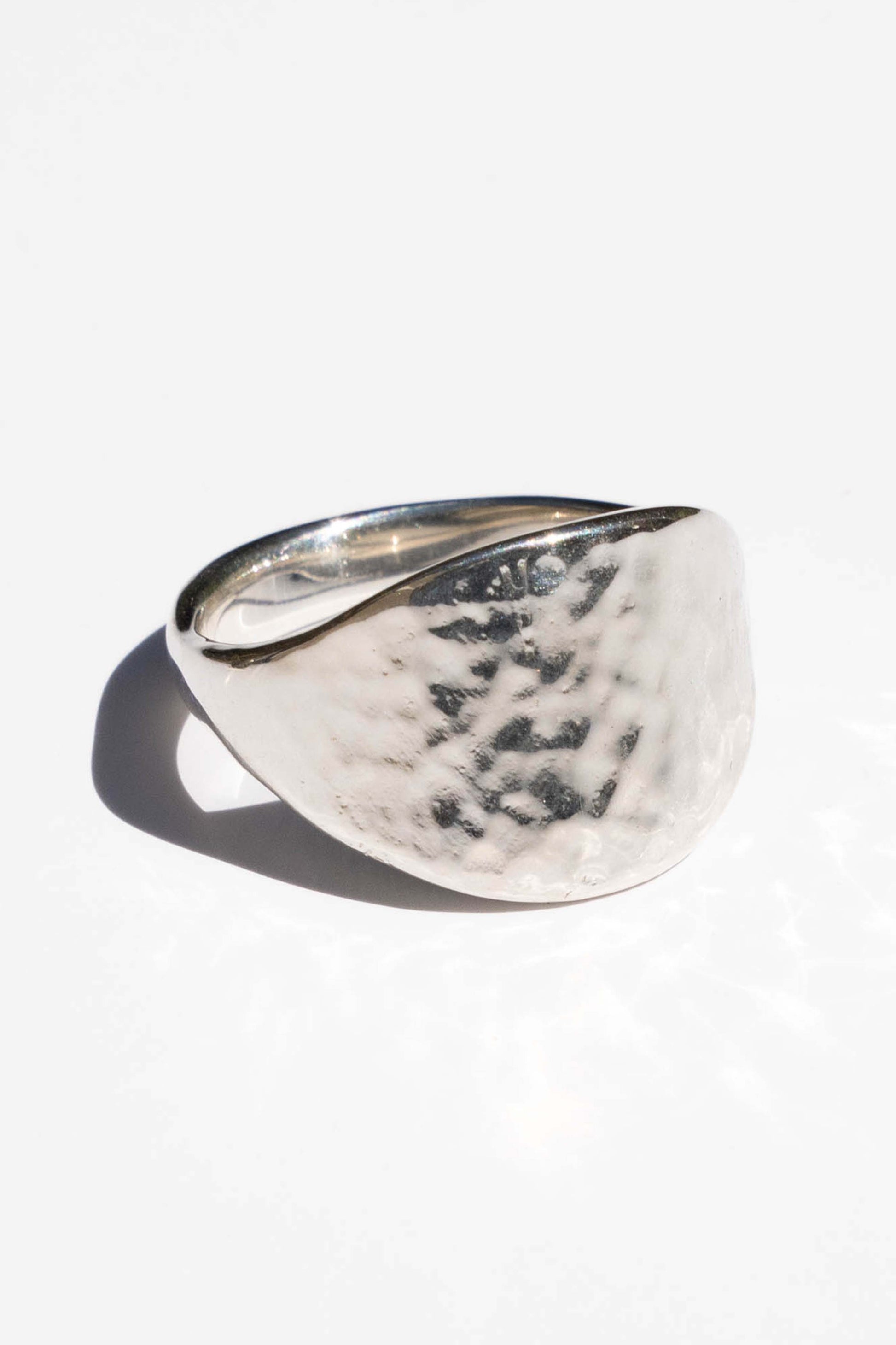Silver ring with a textured surface on a white background. Moneh Brisel The Sun Ring