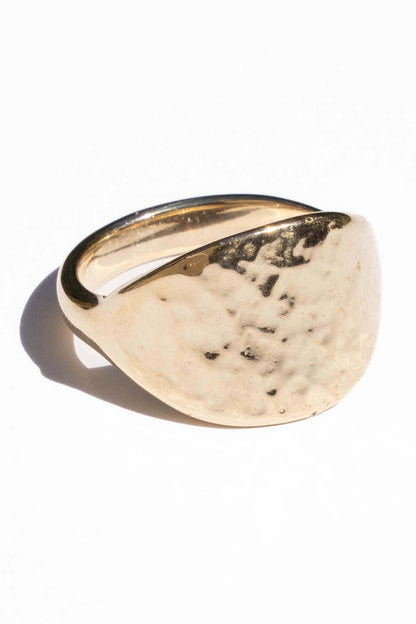 Gold ring with a textured surface on a white background. Moneh Brisel The Sun Ring