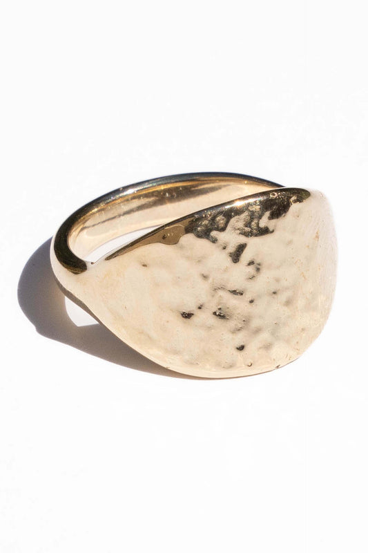 Gold ring with a textured surface on a white background. Moneh Brisel The Sun Ring
