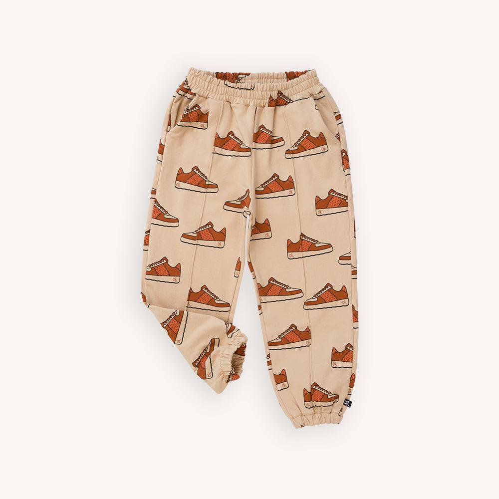 Light brown based jogger with a sneaker print made with 95% organic cotton. Ethically produced, colorful and fun with an eye towards comfort, style and joy. Modern and sustainable kids clothing by CarlijnQ of the Netherlands.