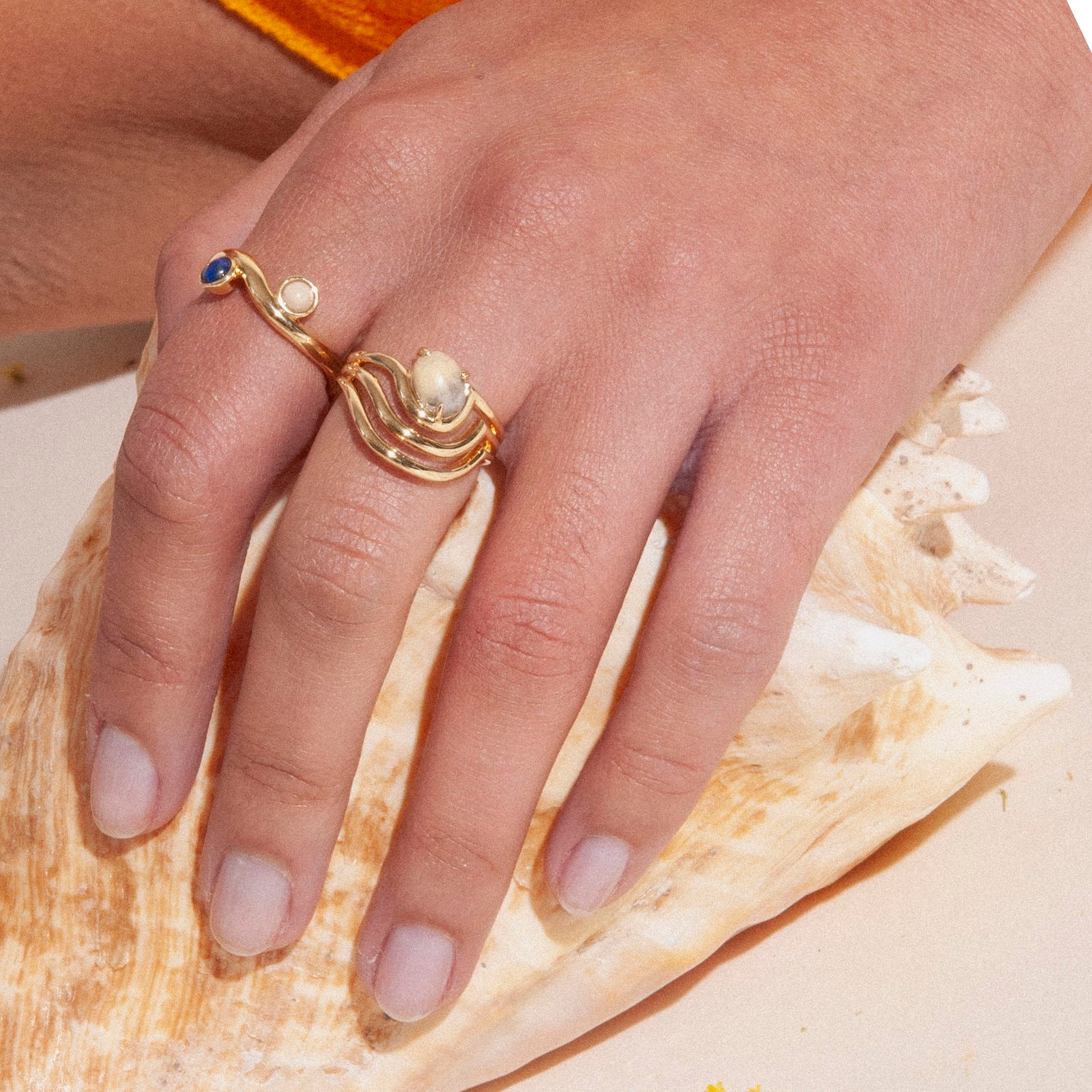 The sway ring features curved lines that flow around a diagonal set crazy lace agate stone. Updated style tapers the underside of the band for a very comfortable fit, rounding all the edges, and dipping it in gold for a bright shine. Handmade by Lindsay Lewis.