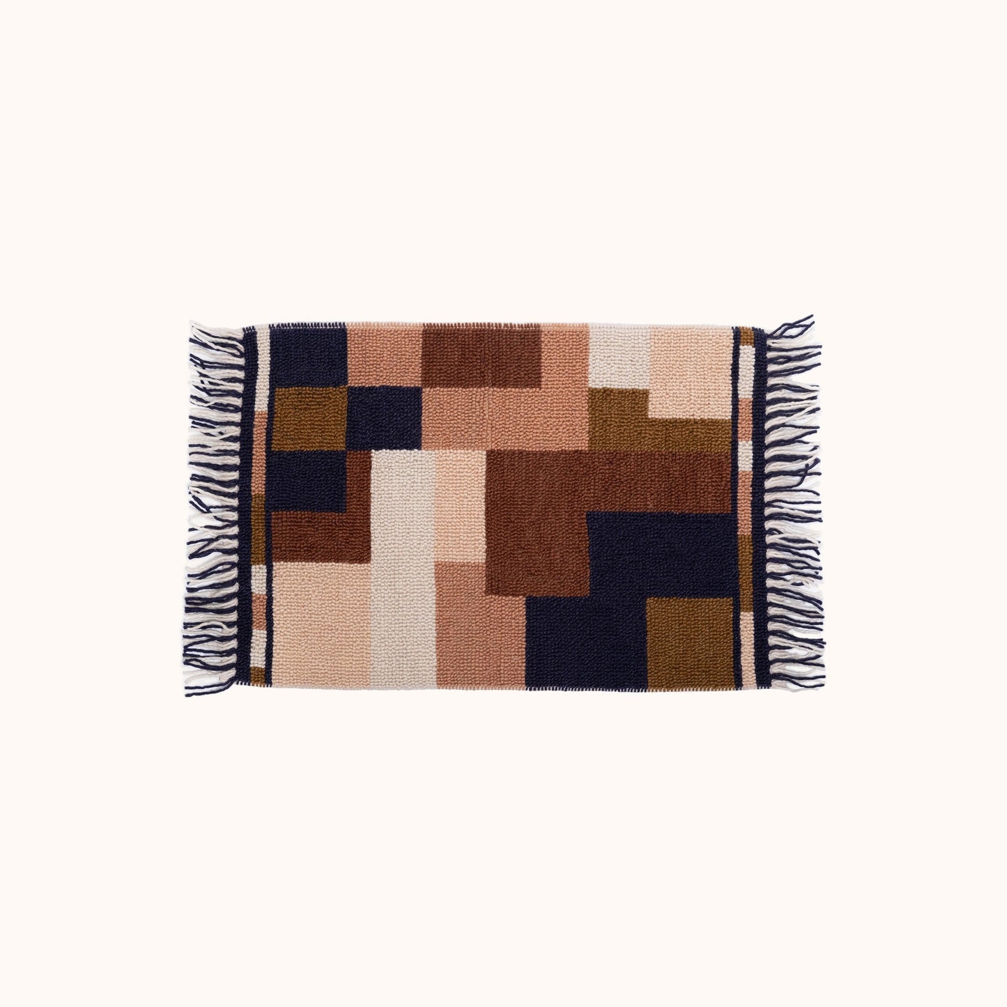 The Oda Rug features a geometric design in a mix of warm earth tones, rich navy, and soft cream. This hand woven, vintage inspired rug is an easy way to add pattern and color to any space. Ethically produced and hand woven in India.