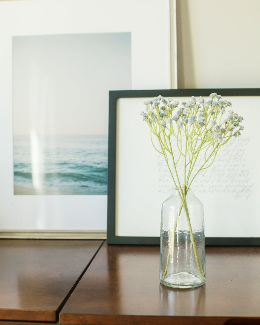 sienna hammered glass bud vase . Ideal for showcasing a single bloom or a small bouquet, these bud vases bring a touch of subtle texture to any space while honoring a commitment to people and the planet.