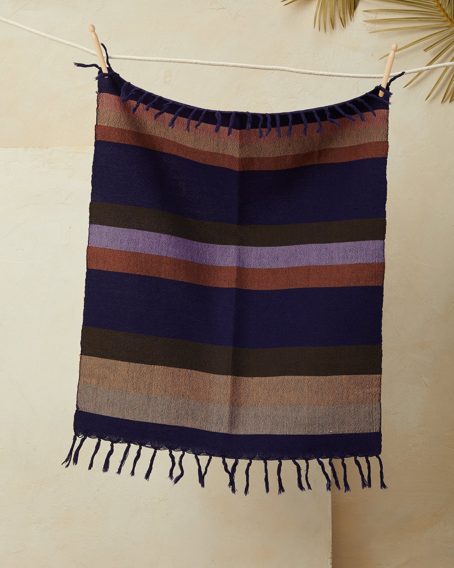 This tea towel is a classic yet modern addition to any kitchen or bathroom. Soft enough to function as hand towels, and durable enough to soak up spills around the kitchen. You can also use them as a centerpiece of a coffee or dining table. Finished with a rustic edge and fringe. Handwoven in Oaxaca, Mexico.