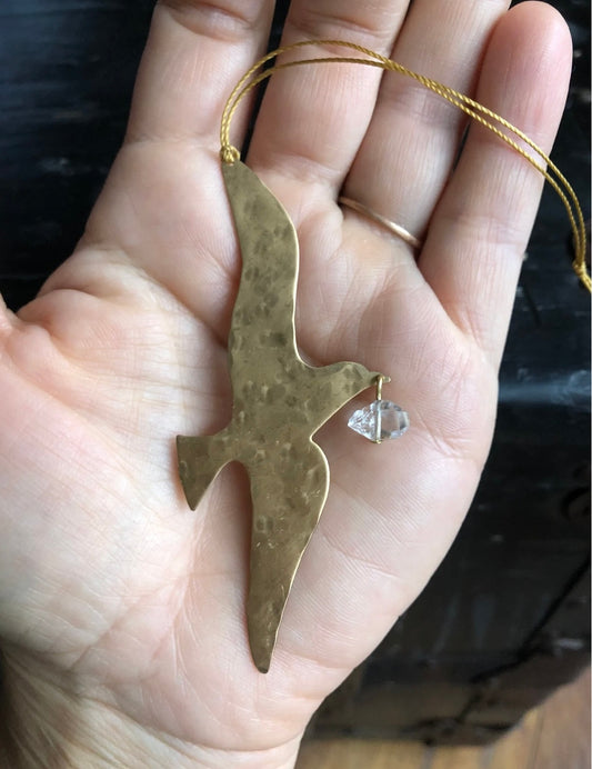 Artisan-crafted story ornament made from hand-cut/hammered brass sheet. Ready to hang.Ornament measures roughly 4.5” tall not including hanging twine.