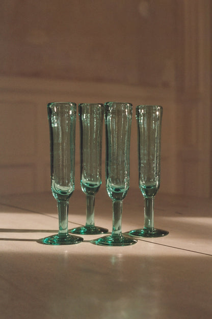 A playful champagne flute with a unique silhouette, designed to keep the party going. Each glass is handmade from recycled glass by artisan partners in Bogotá, Colombia, giving every piece its own subtle character.