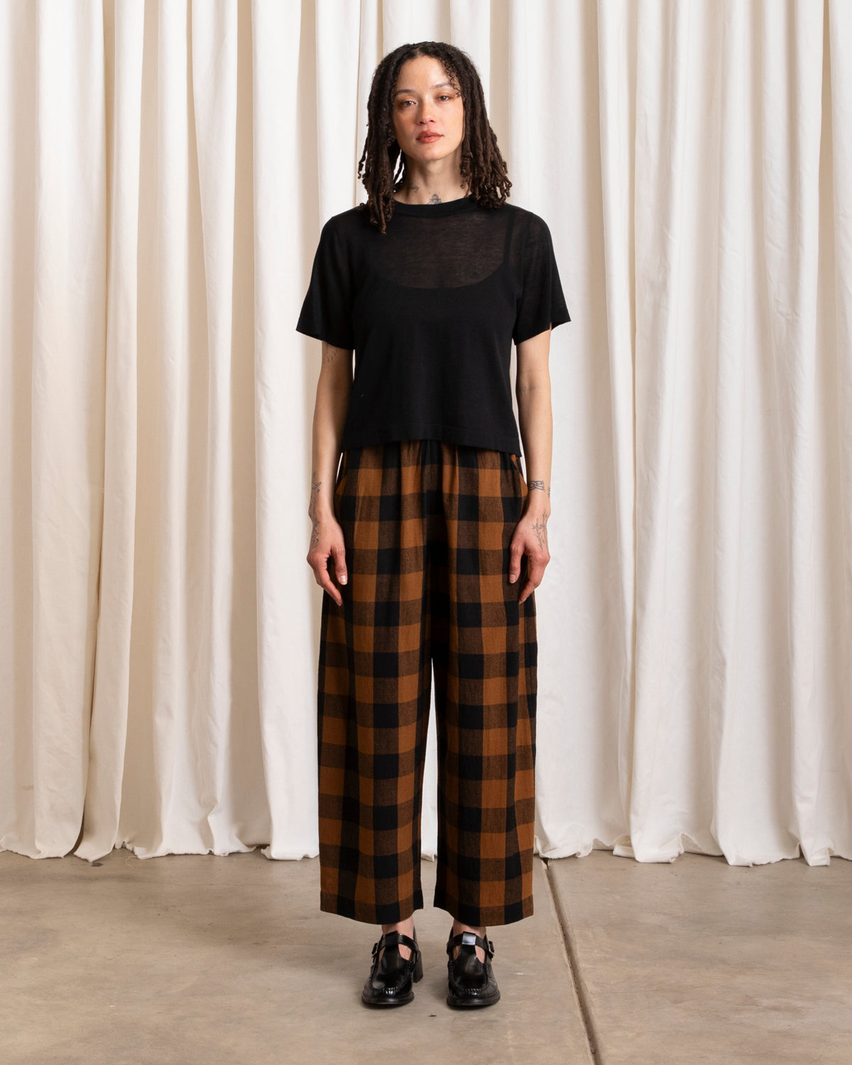 ali golden / An elastic waist pant in raw silk with poppy/pink plaid pattern and barrel pant silhouette.