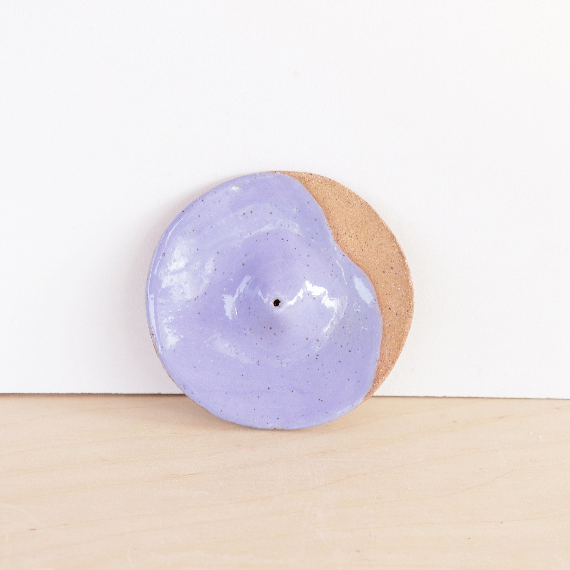 Modern, minimalist incense holder. Made of a speckled stoneware clay, finished with white or lavender glaze. 