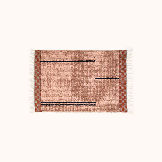The Amari Rug features hand woven looped tufting with an abstract broken stripe design and subtle terracotta bands at both ends. The 2' x 3’ size is perfect for next to the bed or as a layering piece throughout the home. Ethically produced and hand woven in India.